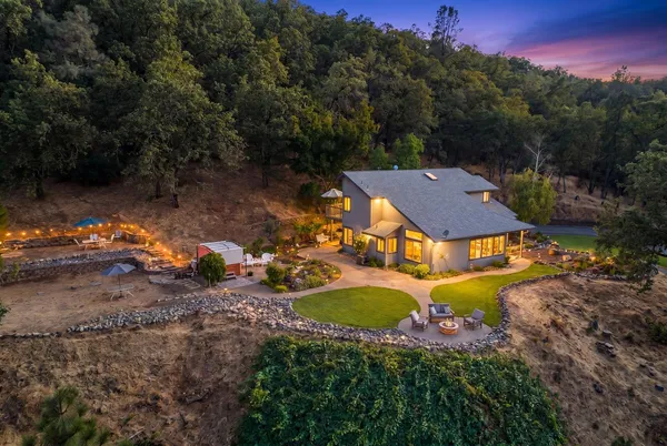 an aerial view of a house with yard swimming pool and outdoor seating