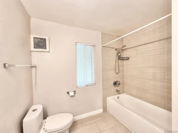 a bathroom with a toilet a sink and bathtub