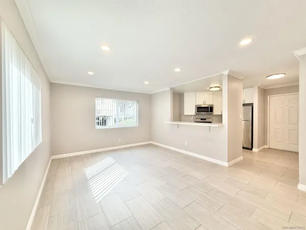 a view of kitchen with refrigerator and window