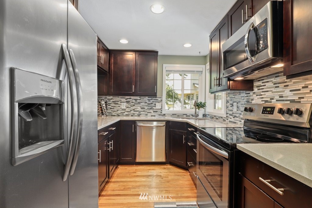 2102 186th Place Southeast Bothell, WA 98012 - Photo 14 of 31 a kitchen with stainless steel appliances granite countertop a stove and a refrigerator