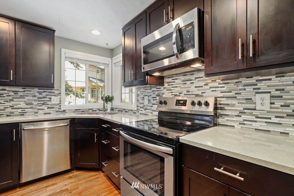 2102 186th Place Southeast Bothell, WA 98012 - Photo 15 of 31 a kitchen with a sink stove and microwave