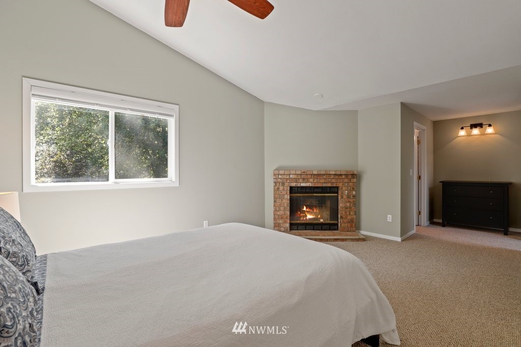 2102 186th Place Southeast Bothell, WA 98012 - Photo 18 of 31 a bedroom with a bed and a fireplace