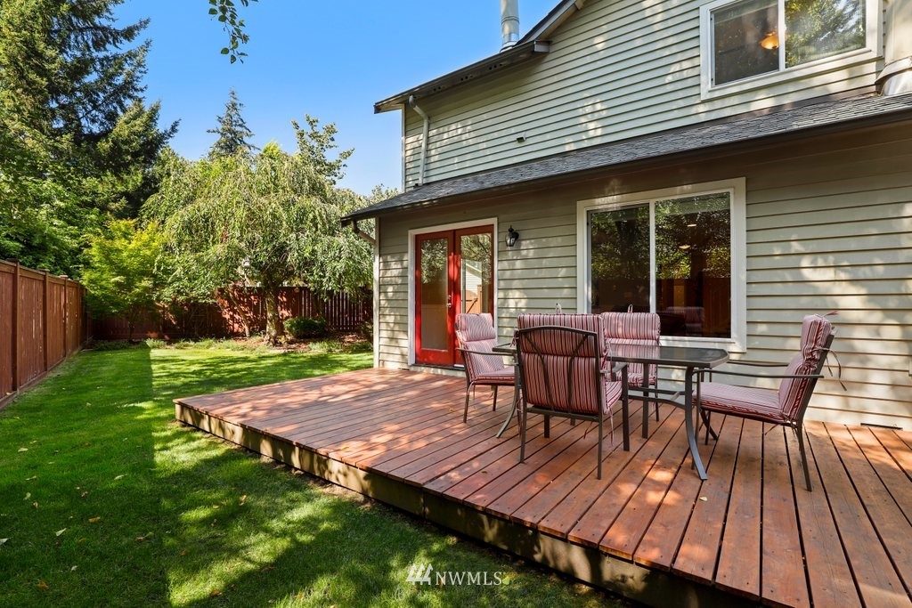 2102 186th Place Southeast Bothell, WA 98012 - Photo 27 of 31 a view of a wooden deck with table and chairs