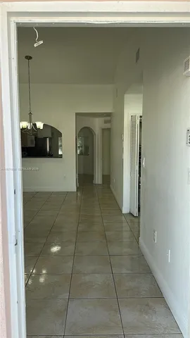 a kitchen with a refrigerator and cabinets