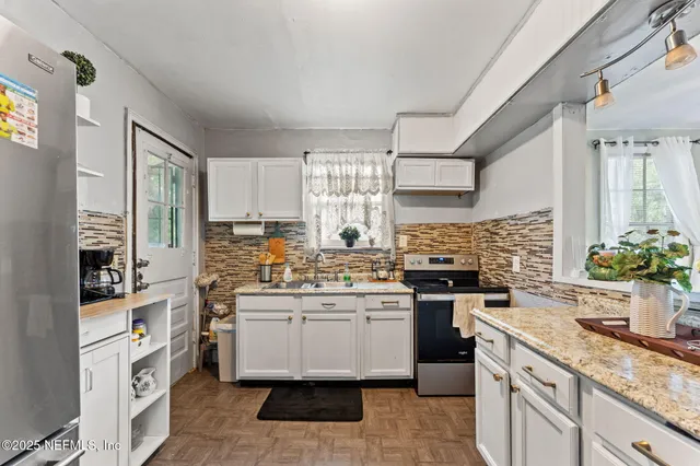 a kitchen with a sink stove and cabinets