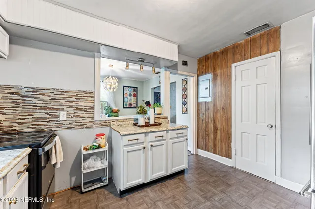 a kitchen that has a lot of cabinets in it