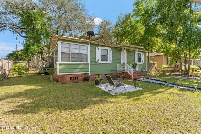 a view of a house with backyard porch and sitting area