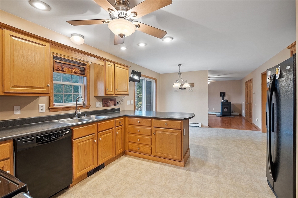 819 West Street Lunenburg, MA 01462 - Photo 25 of 42 a large kitchen with a sink and dishwasher a stove top oven with wooden floor
