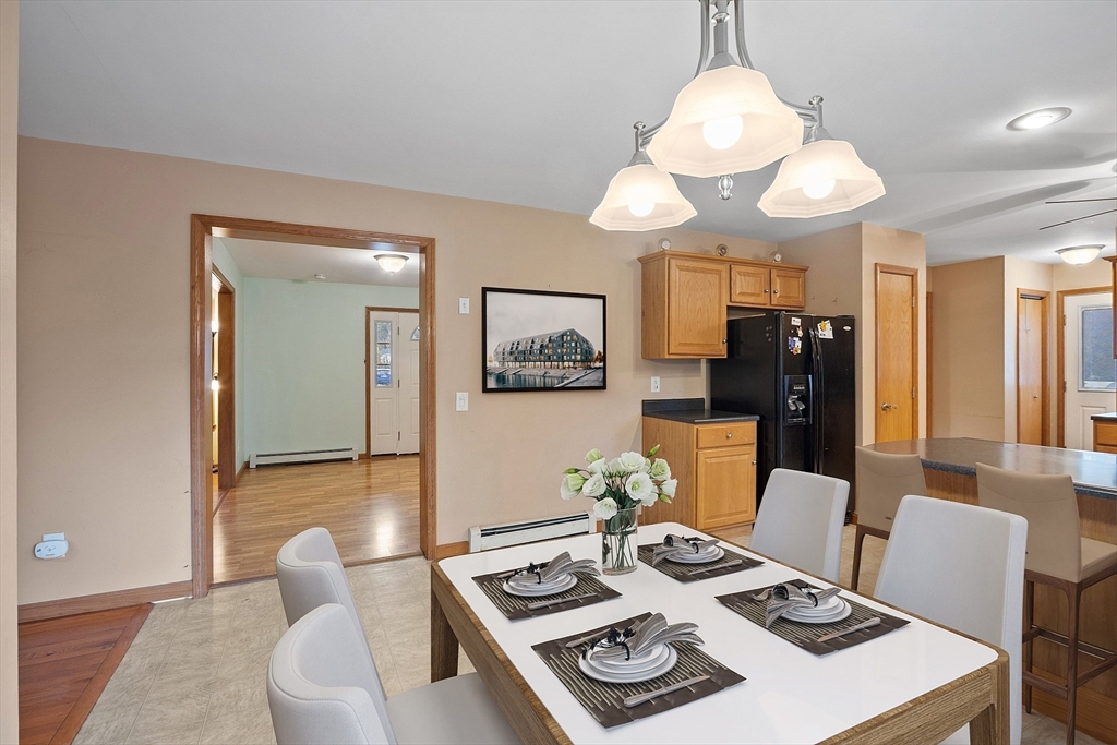 819 West Street Lunenburg, MA 01462 - Photo 26 of 42 a view of a dining room with furniture and a chandelier