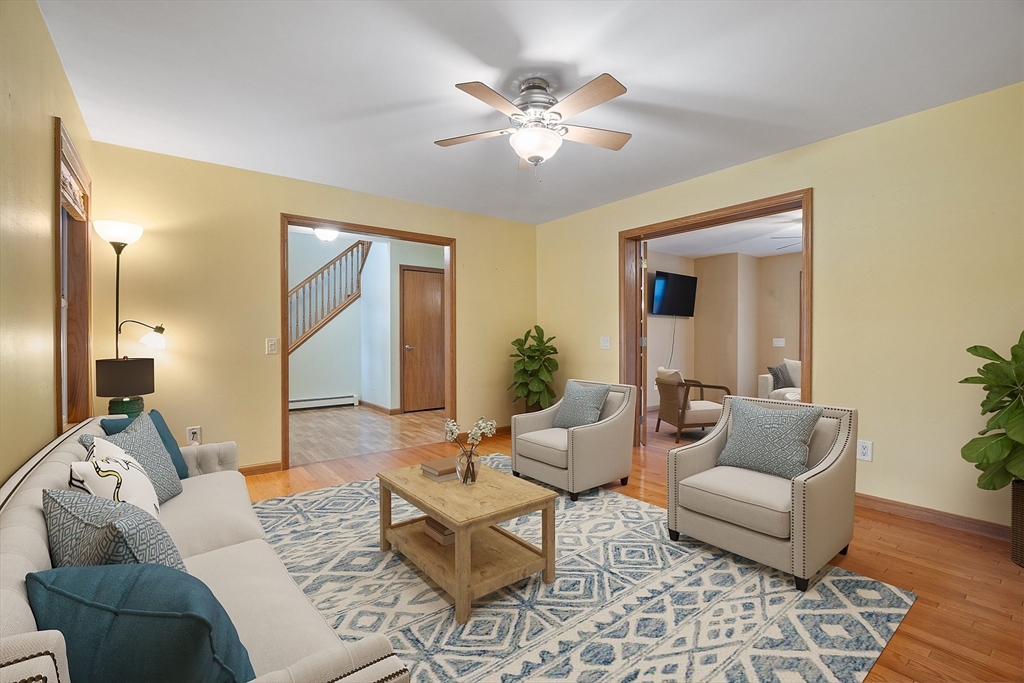 819 West Street Lunenburg, MA 01462 - Photo 29 of 42 a living room with furniture and a chandelier