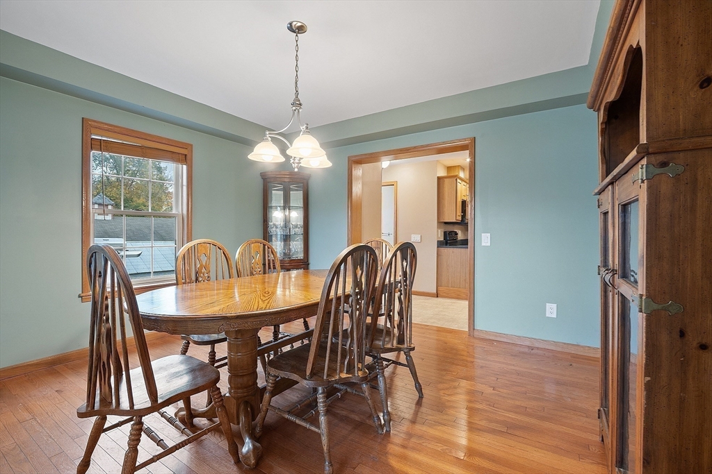 819 West Street Lunenburg, MA 01462 - Photo 32 of 42 a dining room with furniture a chandelier and wooden floor