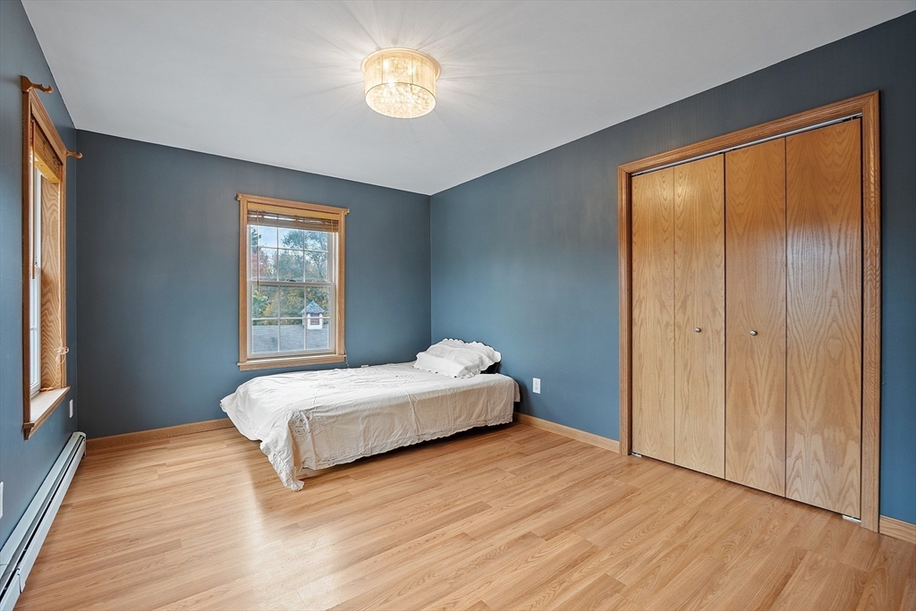 819 West Street Lunenburg, MA 01462 - Photo 39 of 42 a spacious bedroom with a bed and a window