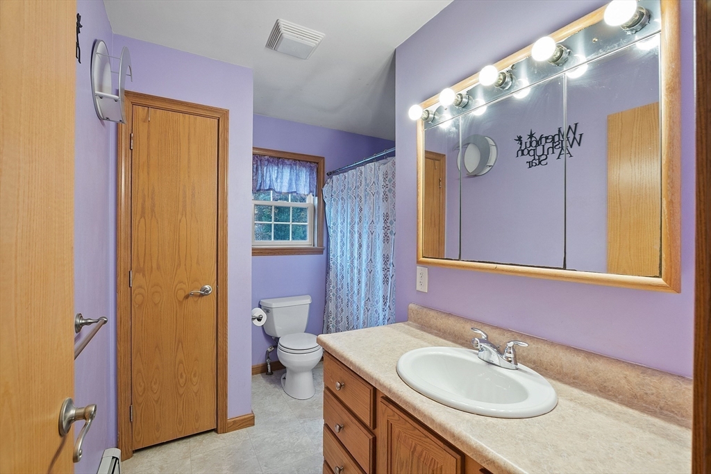819 West Street Lunenburg, MA 01462 - Photo 40 of 42 a bathroom with a granite countertop sink and a mirror