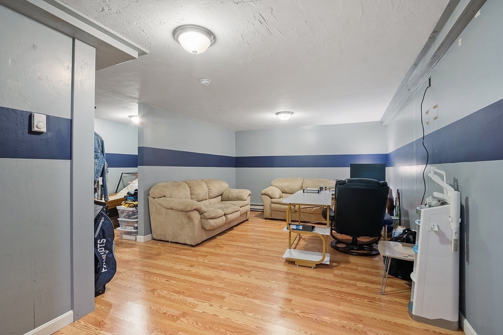 819 West Street Lunenburg, MA 01462 - Photo 42 of 42 a living room with furniture and a flat screen tv