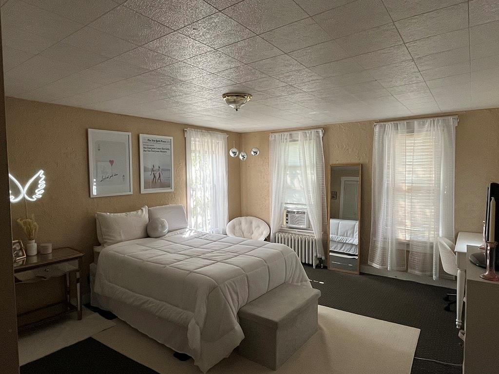 451-453 Philadelphia Street Indiana, PA 15701 - Photo 6 of 23 a bedroom with a bed a mirror on dresser and a large window