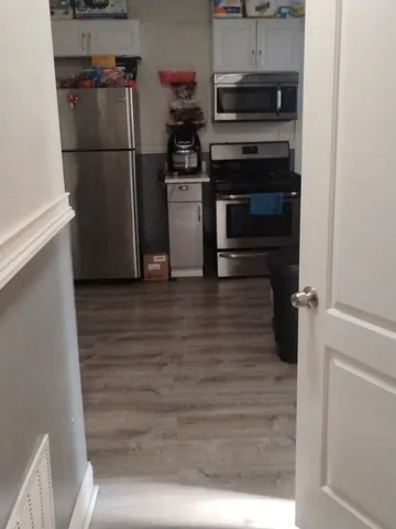 a kitchen with a stove microwave and cabinets