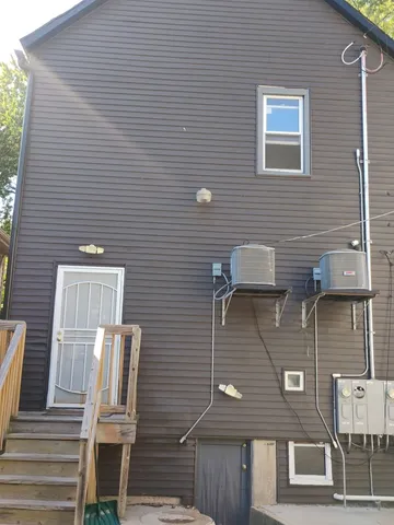 a backyard of a house with table and chairs