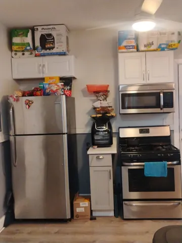 a white refrigerator freezer and a stove sitting inside of a kitchen
