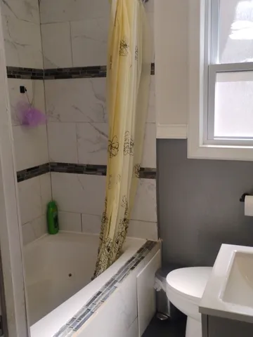 a view of a bedroom with a bed and a window