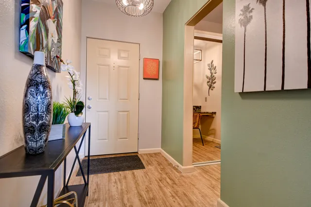 a dining room with furniture and wooden floor