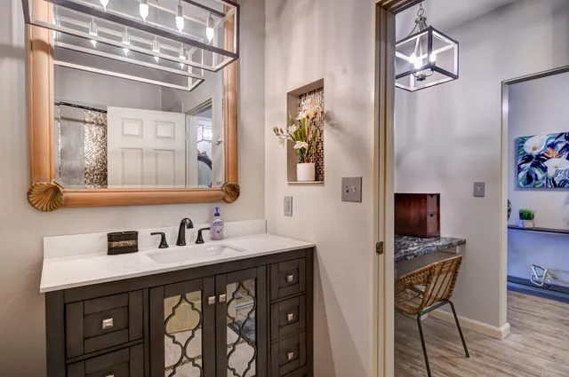 a view of a patio with table and chairs under an umbrella with a small yard