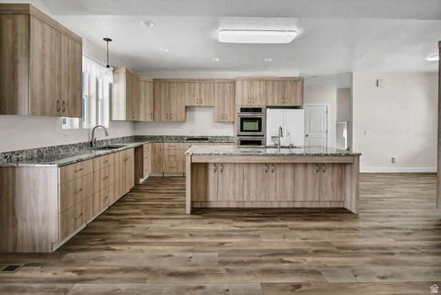 1103 North Brooklyn Road Monroe, UT 84754 - Photo 13 of 78 Kitchen featuring light stone counters, light brown cabinets, light wood-style floors, decorative light fixtures, and recessed lighting