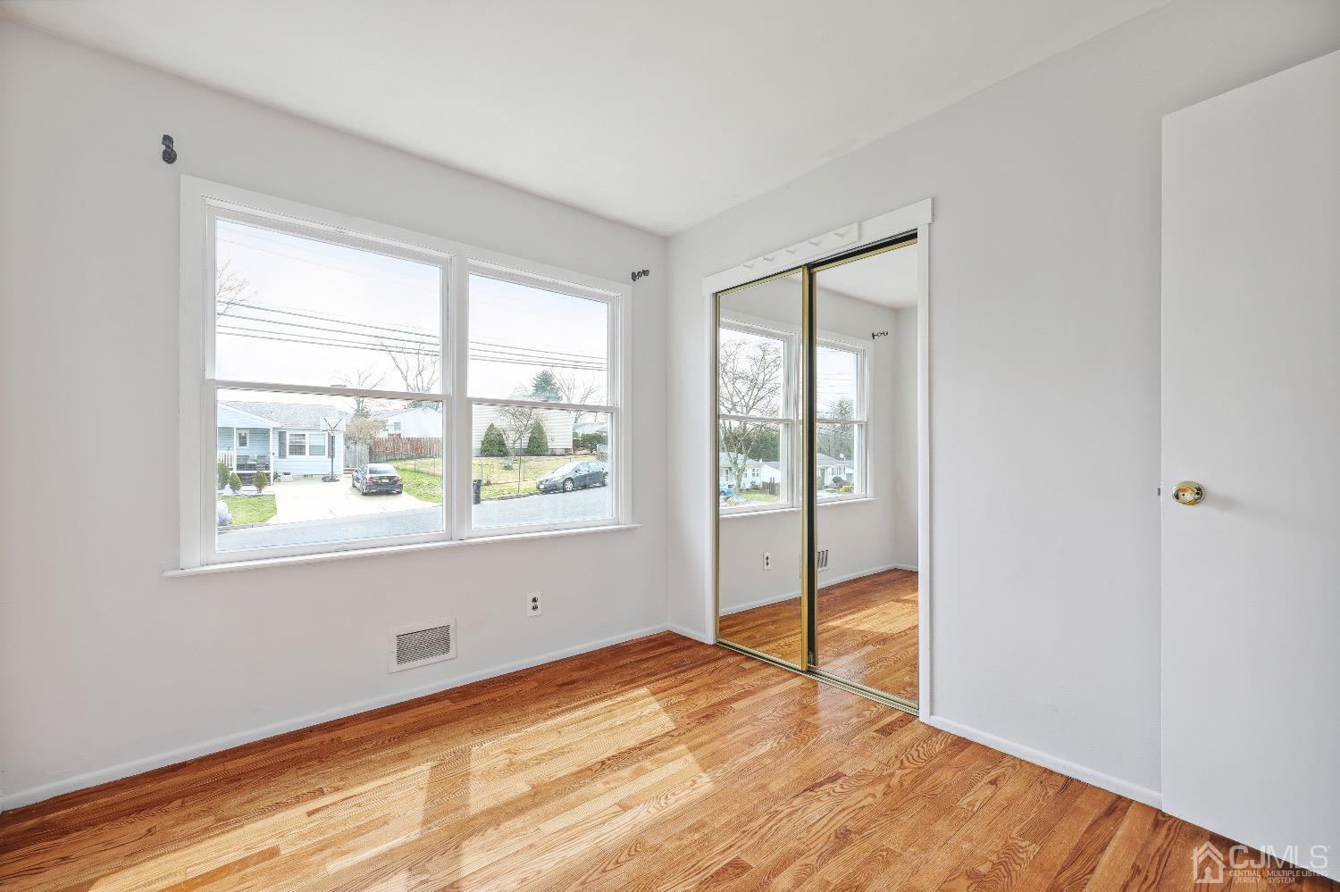 21 Rutgers Road Old Bridge, NJ 08859 - Photo 11 of 27 a view of empty room with wooden floor and fan