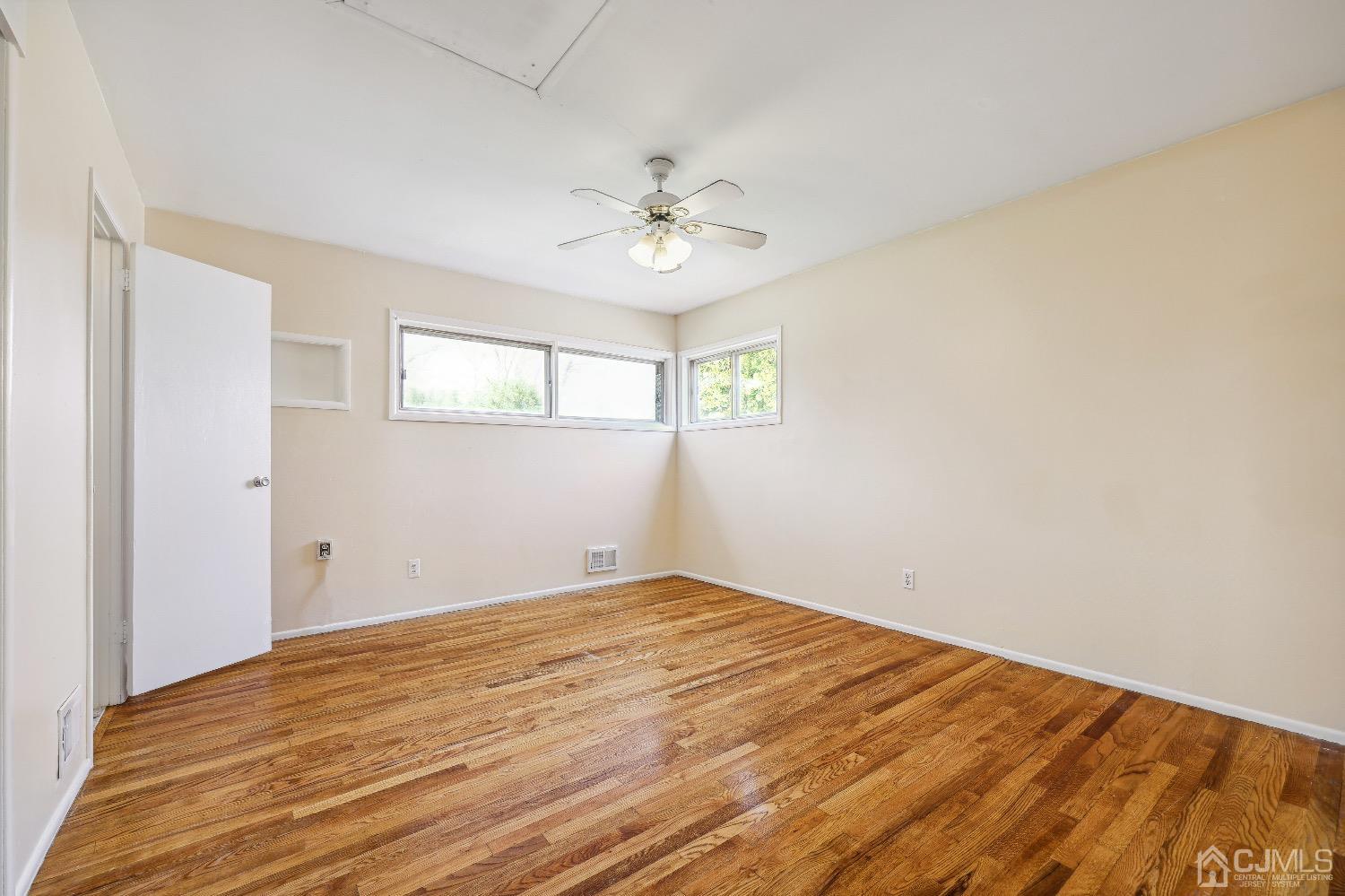 21 Rutgers Road Old Bridge, NJ 08859 - Photo 12 of 27 an empty room with windows and fan