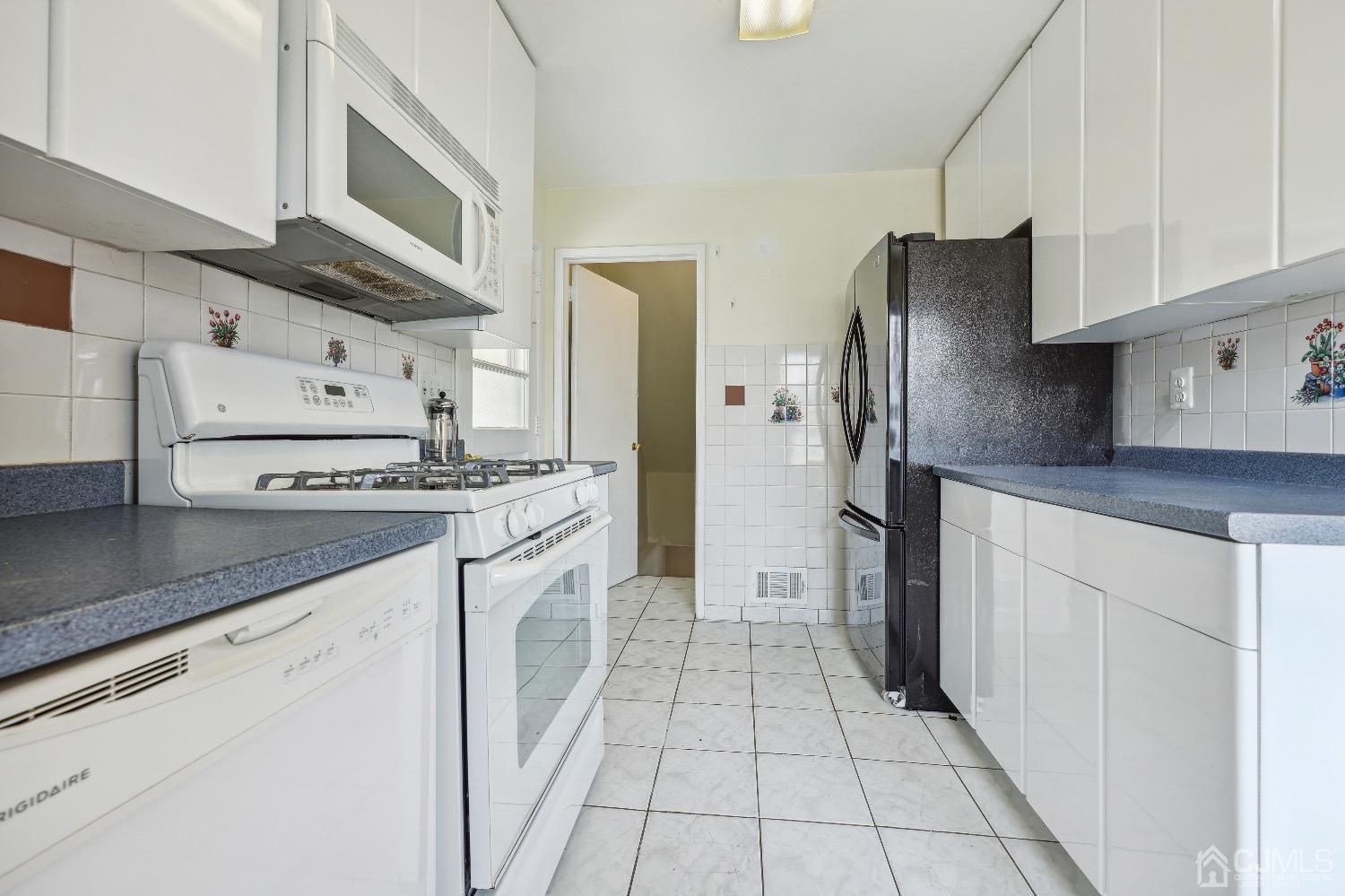 21 Rutgers Road Old Bridge, NJ 08859 - Photo 17 of 27 a kitchen with stainless steel appliances granite countertop a refrigerator and a stove top oven