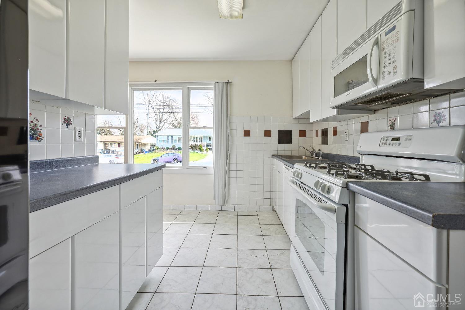 21 Rutgers Road Old Bridge, NJ 08859 - Photo 18 of 27 a kitchen with stainless steel appliances granite countertop a stove a sink and a refrigerator