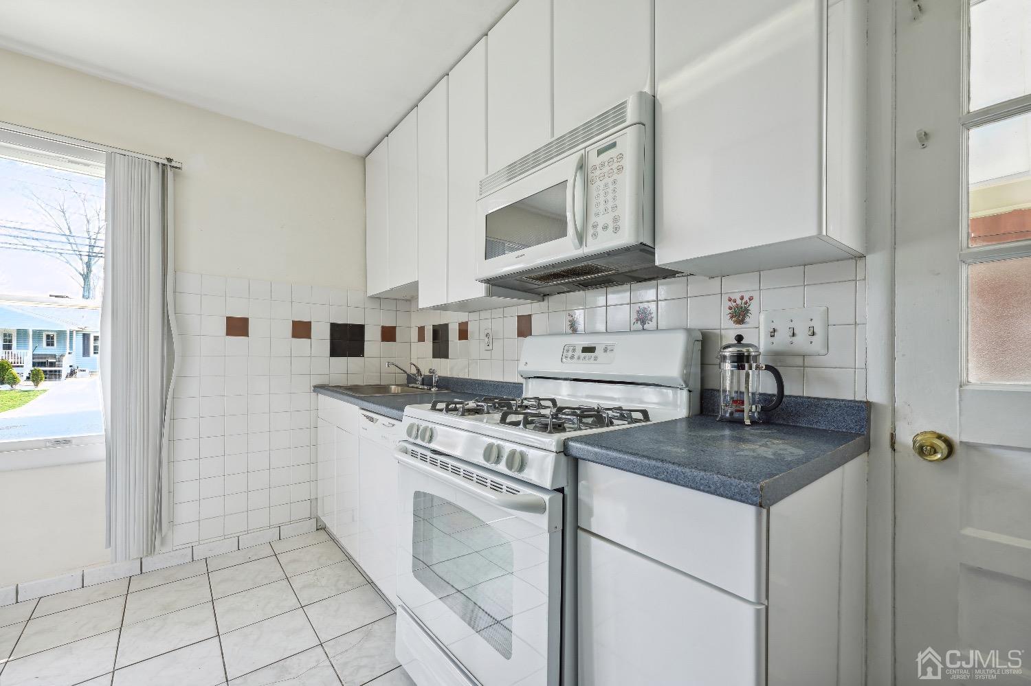 21 Rutgers Road Old Bridge, NJ 08859 - Photo 19 of 27 a kitchen with stainless steel appliances granite countertop a stove a sink and a white refrigerator