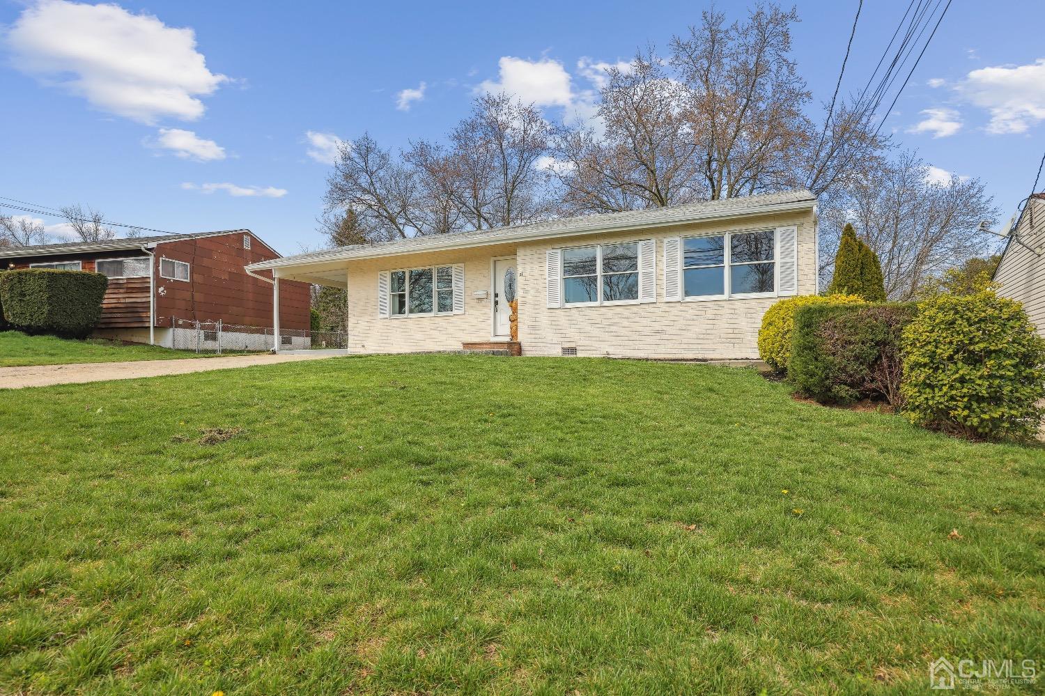 21 Rutgers Road Old Bridge, NJ 08859 - Photo 2 of 27 a front view of a house with a garden and trees