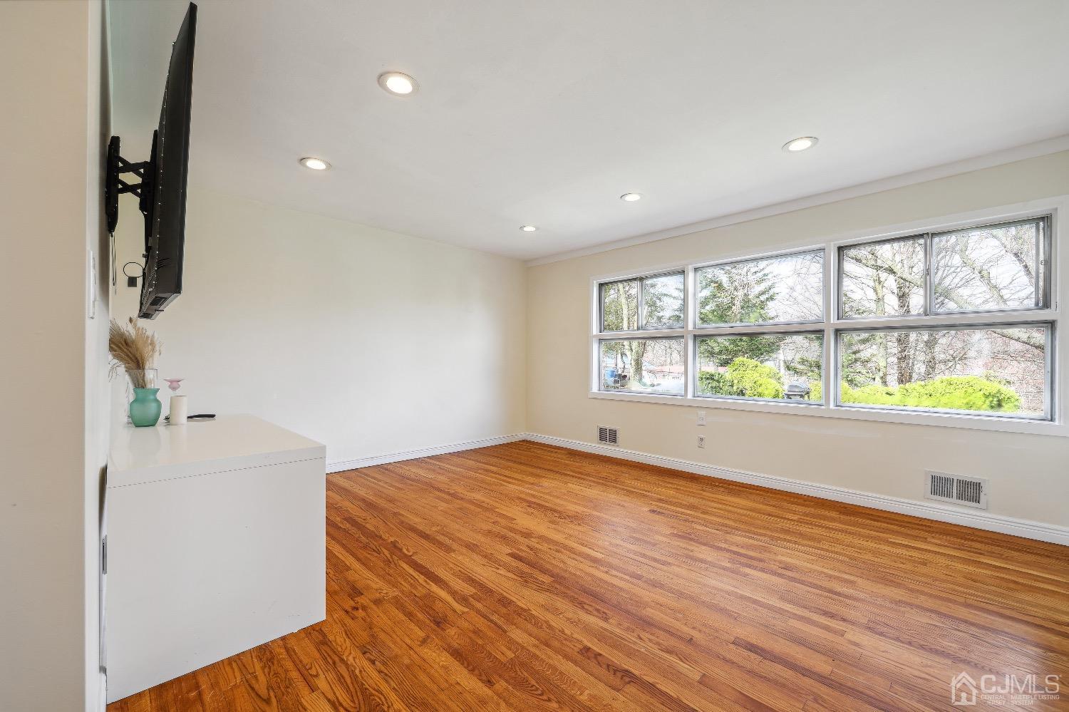 21 Rutgers Road Old Bridge, NJ 08859 - Photo 6 of 27 an empty room with wooden floor and windows