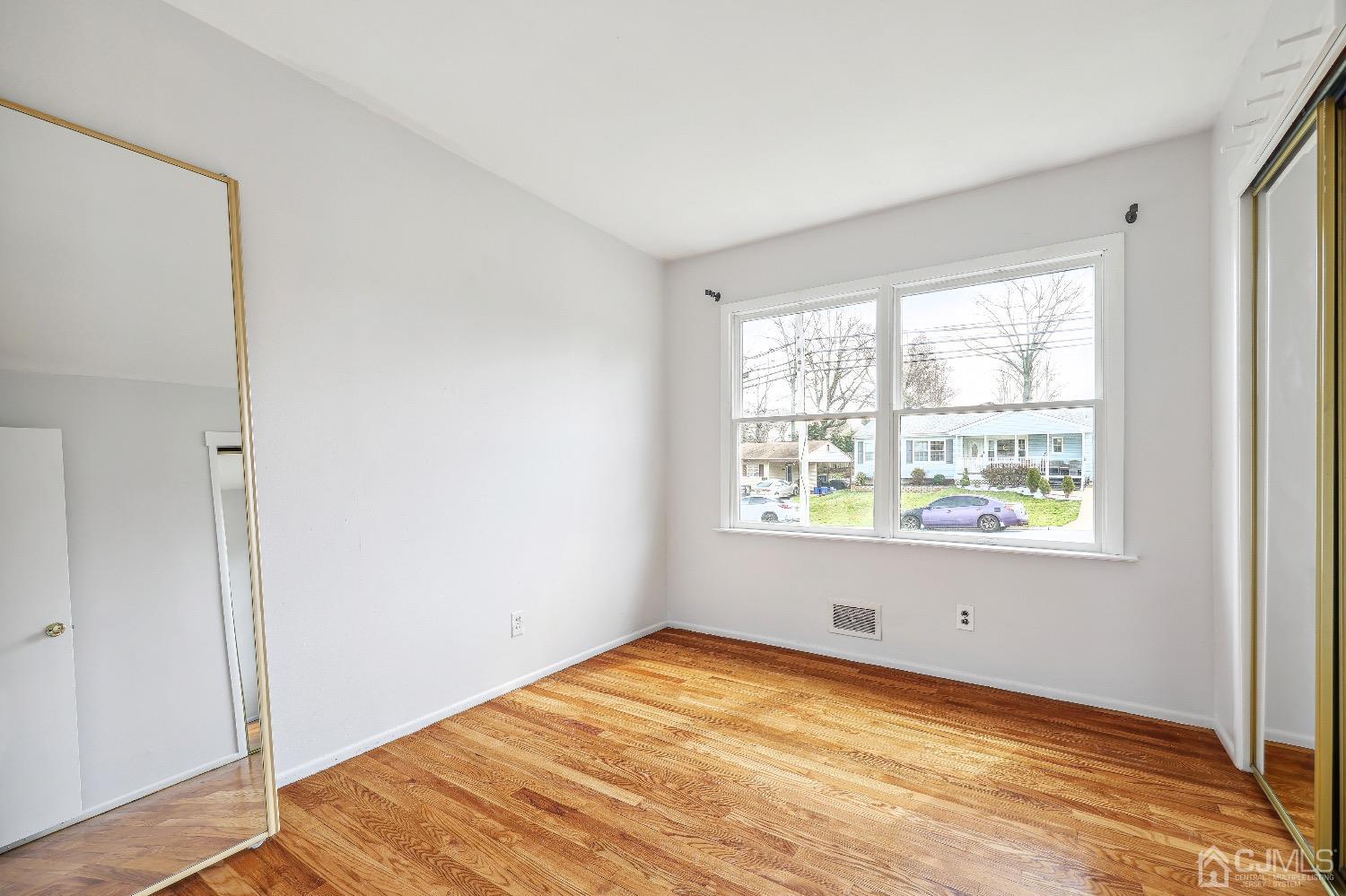 21 Rutgers Road Old Bridge, NJ 08859 - Photo 10 of 27 a view of empty room with wooden floor and fan