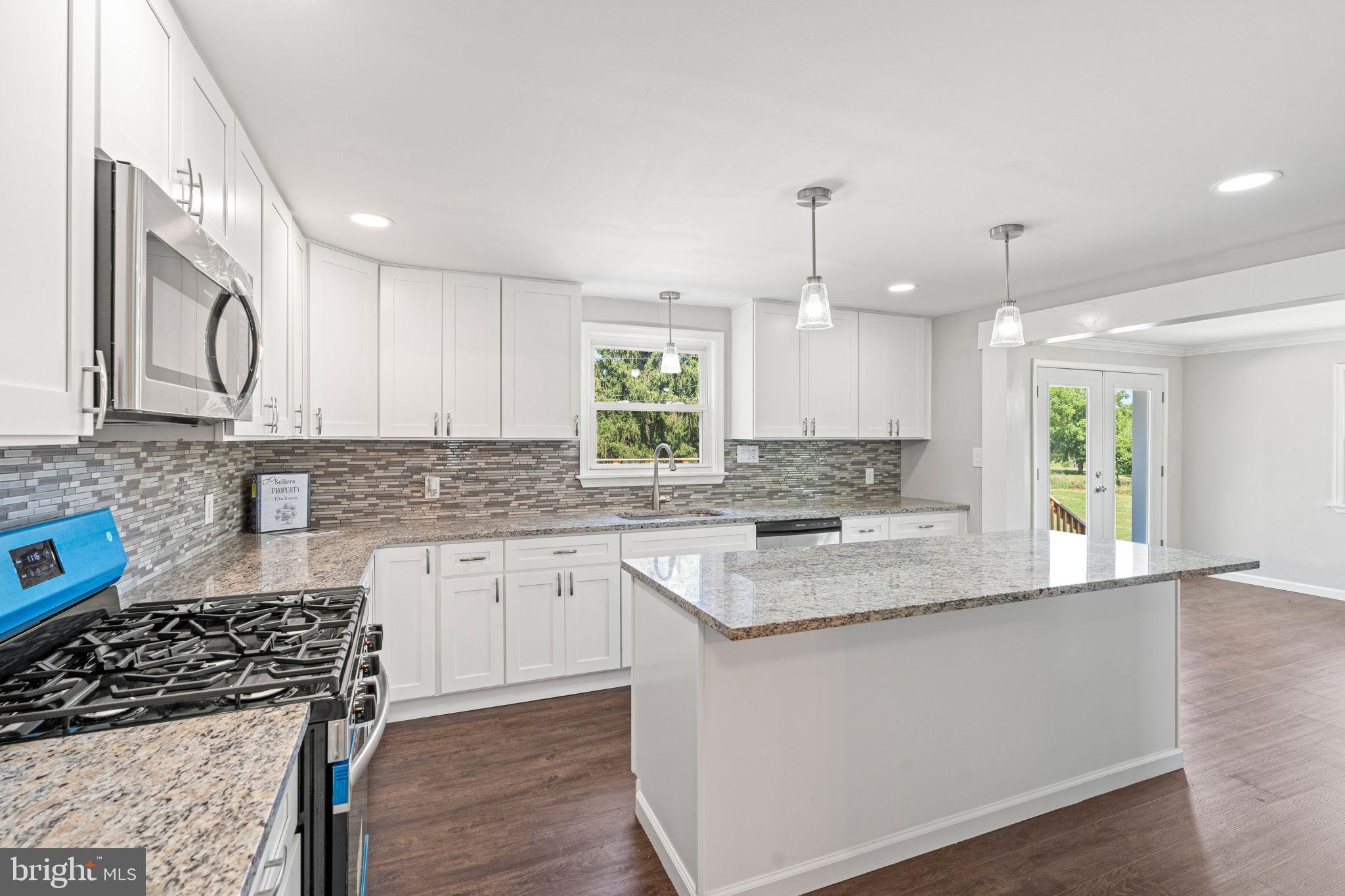 1005 2nd Avenue Manchester, PA 17345 - Photo 17 of 54 a kitchen with stainless steel appliances granite countertop a sink stove and cabinets