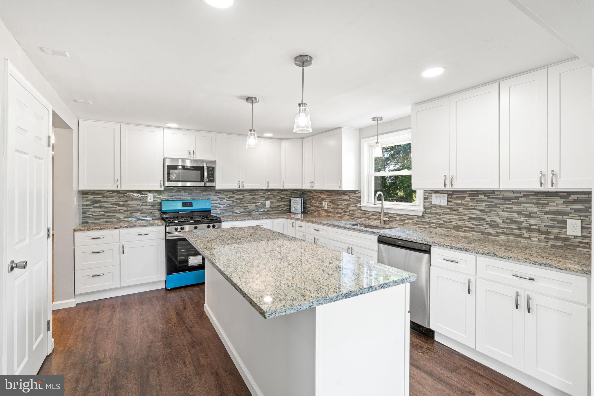 1005 2nd Avenue Manchester, PA 17345 - Photo 18 of 54 a kitchen with granite countertop a sink a counter top space stainless steel appliances and cabinets