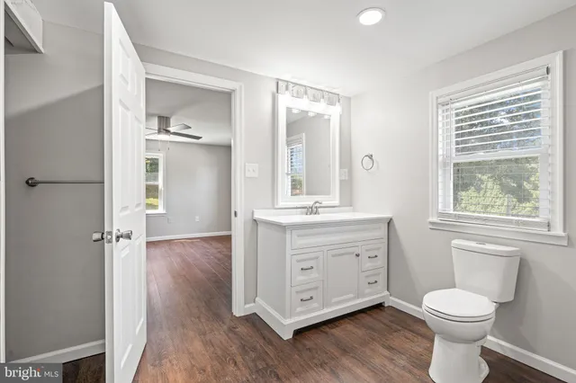 an empty room with windows and closet