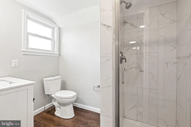 a view of a bedroom with wooden floor