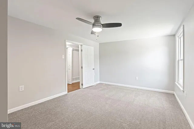 a view of empty room with a fan