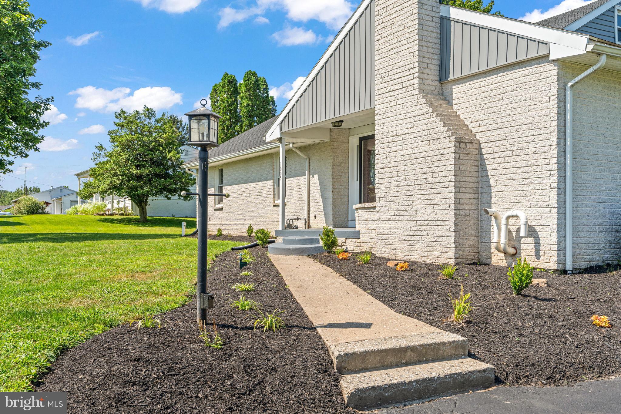 1005 2nd Avenue Manchester, PA 17345 - Photo 6 of 54 a view of a white house next to a yard with big trees