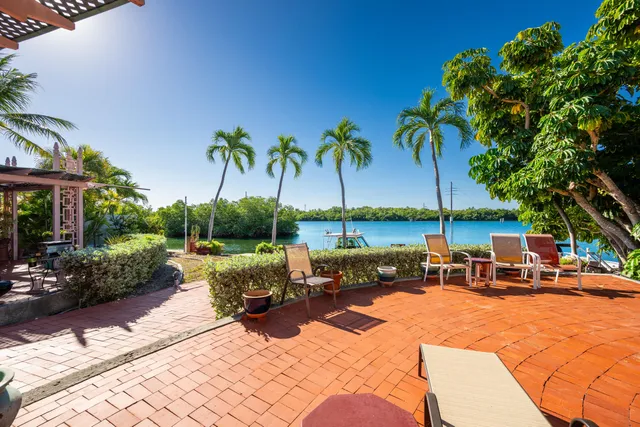 a view of a patio with swimming pool table and chairs
