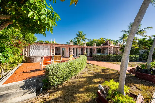 a view of a house with backyard and sitting area