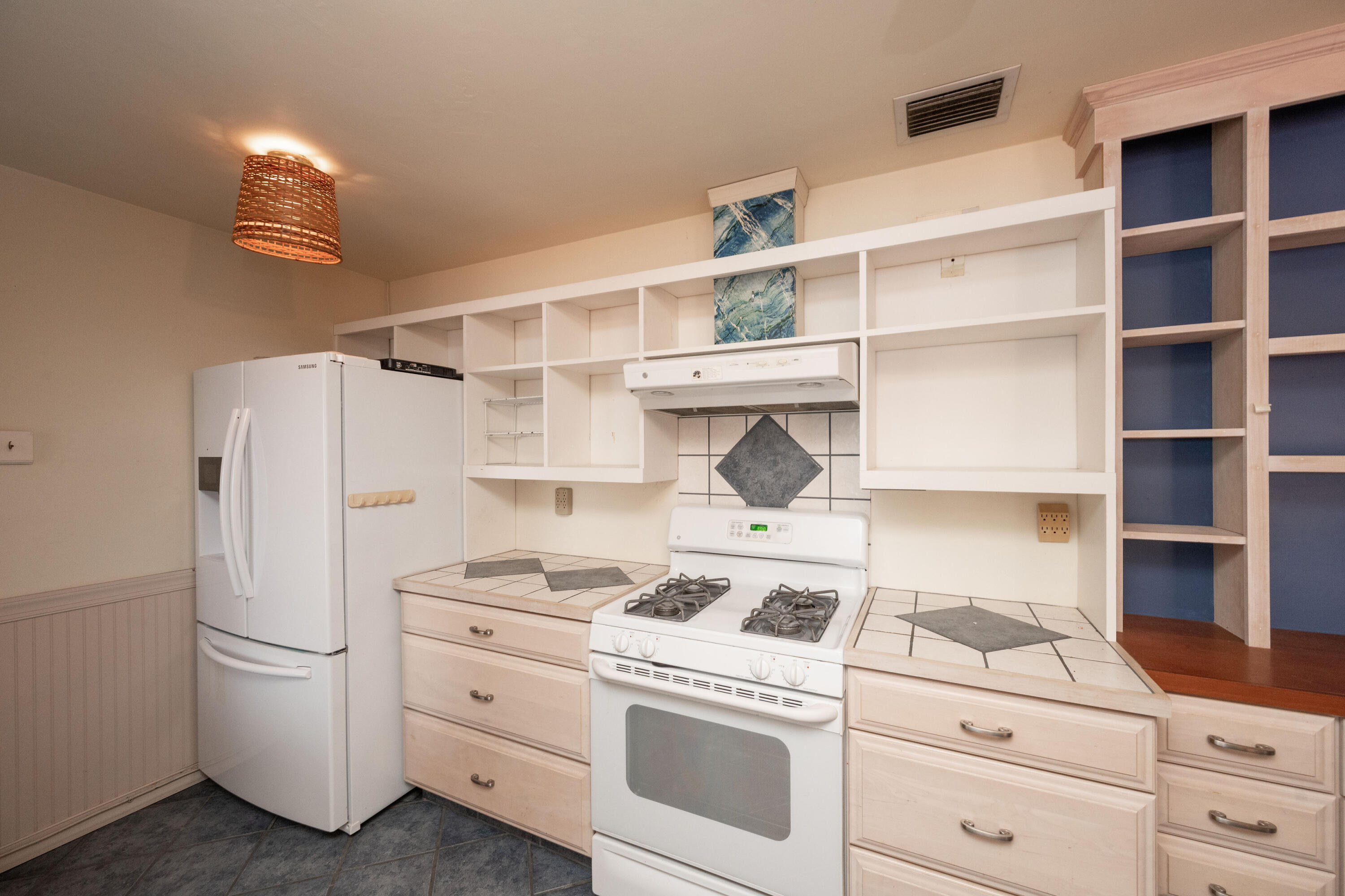103 Key Haven Road Key Haven, FL 33040 - Photo 21 of 36 a kitchen with a white stove refrigerator and cabinets