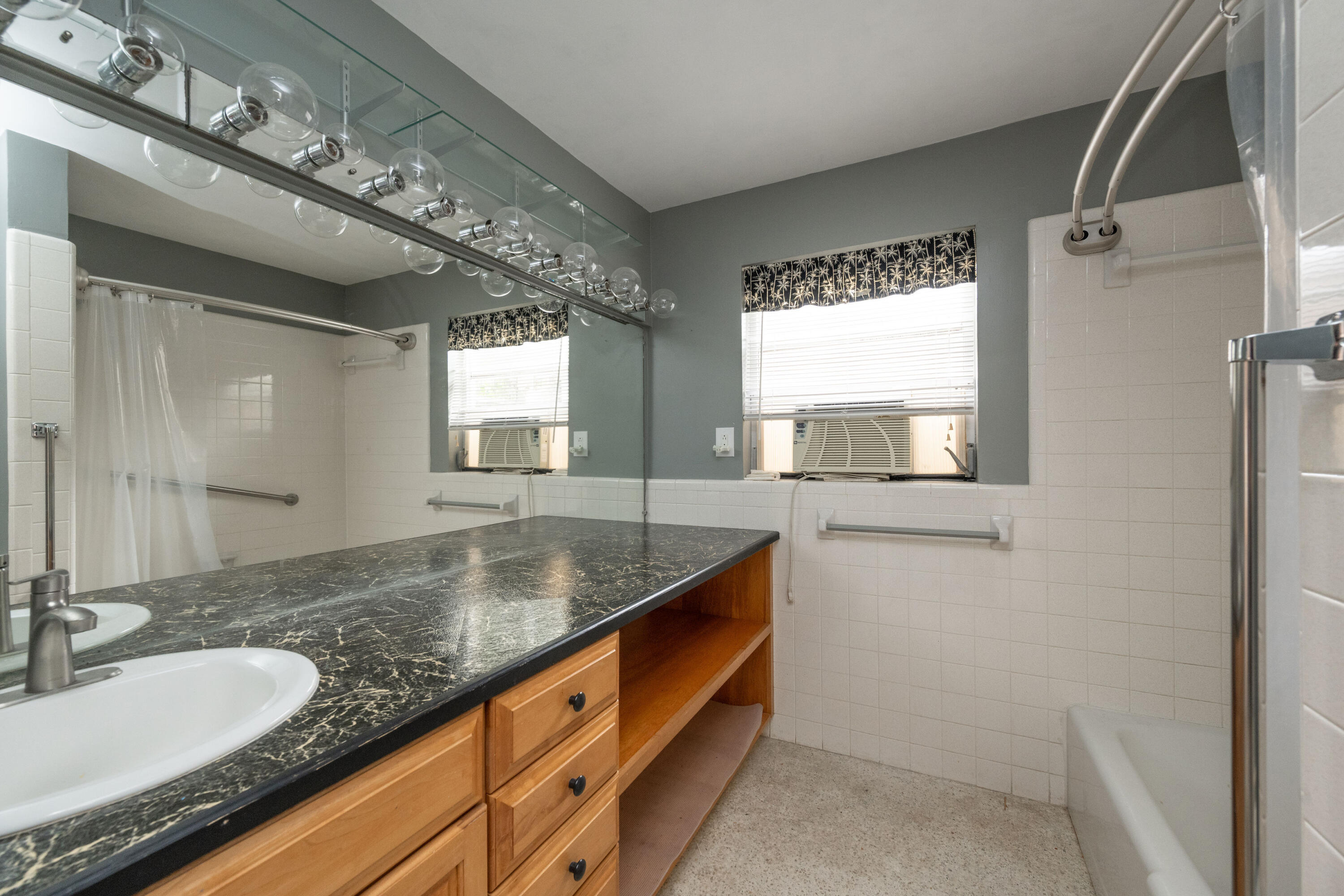 103 Key Haven Road Key Haven, FL 33040 - Photo 31 of 36 a bathroom with a granite countertop sink and a large mirror