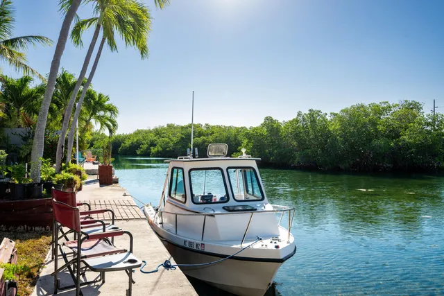 a front view of a house with garden bath tub and seating space