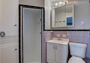 909 Duncan Lane, Unit A Austin, TX 78705 - Photo 16 of 18 a bathroom with a toilet sink and mirror