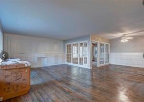 909 Duncan Lane, Unit A Austin, TX 78705 - Photo 8 of 18 a view of an empty room with wooden floor and a fireplace