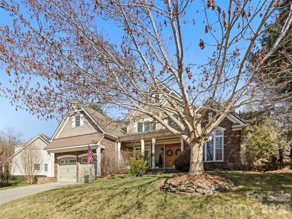 front view of a house with a large tree