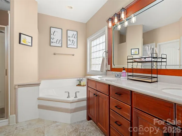 a bathroom with a tub sink and mirror