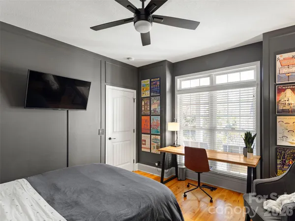 a bedroom that has a bed and a flat screen tv